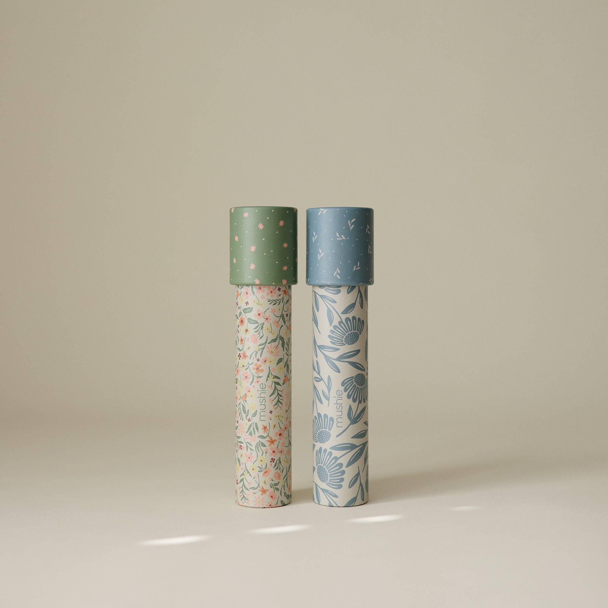 Two mushie Kaleidoscopes, green and blue floral, ideal for creative play.