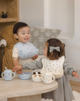 Two toddlers use the Rylee + Cru Feeding Kit Heart Ditsy, smiling together at a small table.