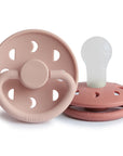 Two FRIGG Moon Silicone Pacifiers—pink 2-pack, baby essentials; one upright, one flat.