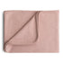 The Mushie Ribbed Baby Blanket, in light pink, is neatly folded on a white background. A turned-up corner displays its soft, breathable fabric and finished edges.