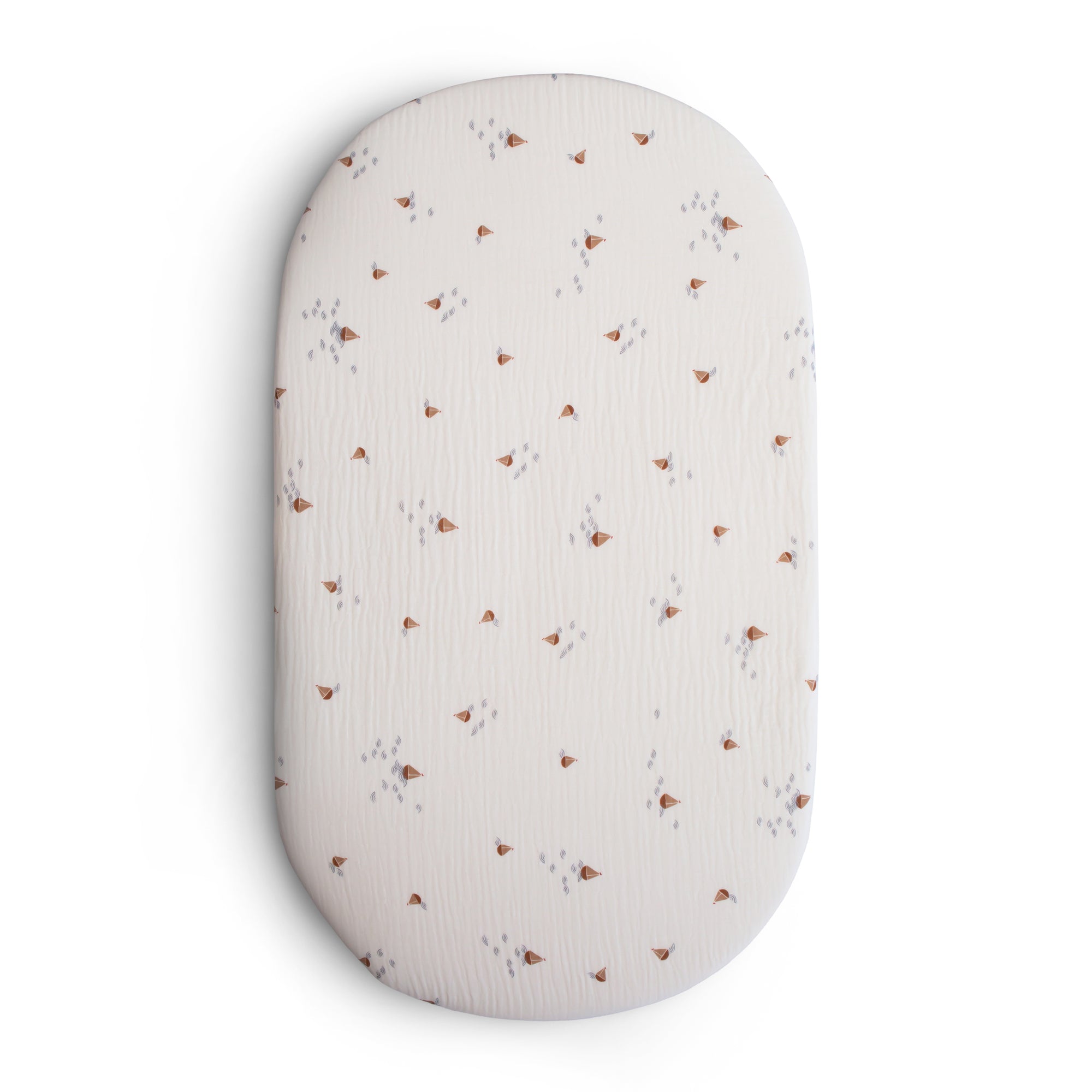 Mushie Extra Soft Bassinet Muslin Crib Sheet in Boats print with tiny brown and gray design.