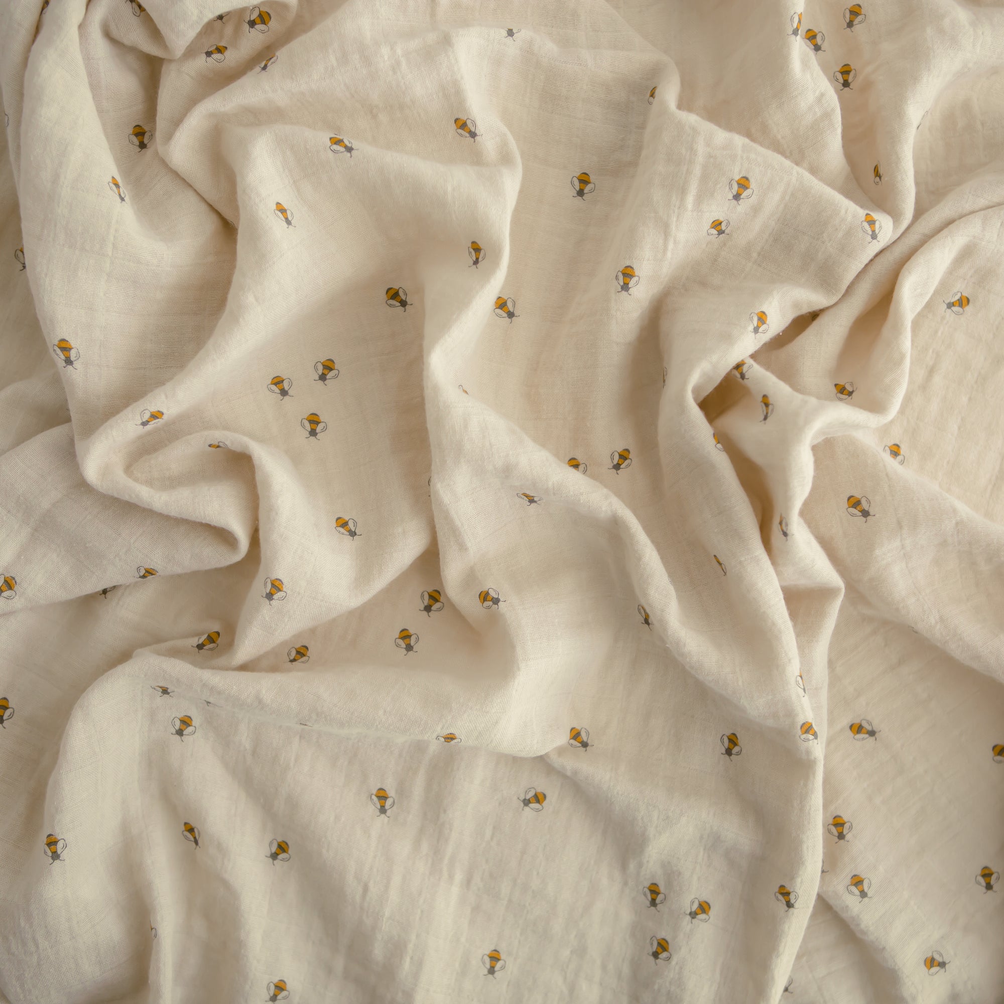 Lifestyle image of Organic Cotton Swaddle in Bees