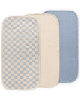 Mushie Changing Pad Liners: three muslin rectangles—checkered, beige, and blue, overlapping.