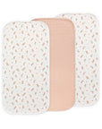 Three Mushie Changing Pad Liners—two floral, one solid pink in the center—organic cotton.