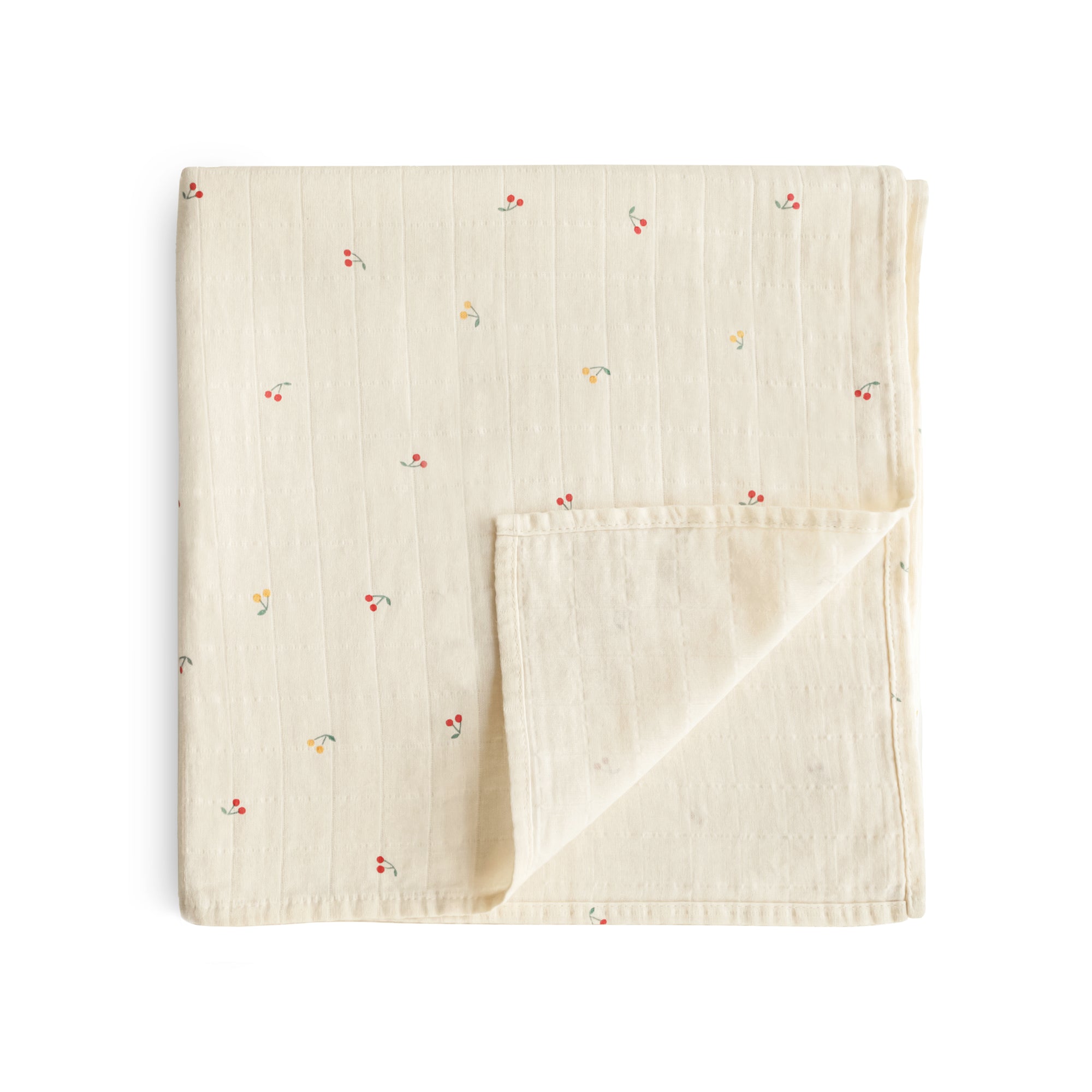 Mushie Organic Cotton Muslin Swaddle Blanket in cream with small florals, folded on white.