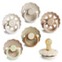 The FRIGG Natural Rubber 6-Pack by FRIGG features six neutral-colored pacifiers with round handles and scalloped or heart-patterned shields, made in Denmark from natural rubber latex. One pacifier is shown with the nipple side up.