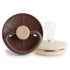 The FRIGG Little Viking Silicone 2-Pack by FRIGG includes two modern, medical grade silicone pacifiers—one brown with a beige handle, the other showing a white nipple and beige rim—designed and made in Denmark.