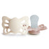 The FRIGG Butterfly Anatomical Silicone Pacifier 2-Pack (0-6 Months) features two beige and pale pink butterfly-shaped pacifiers, designed for your baby's comfort.