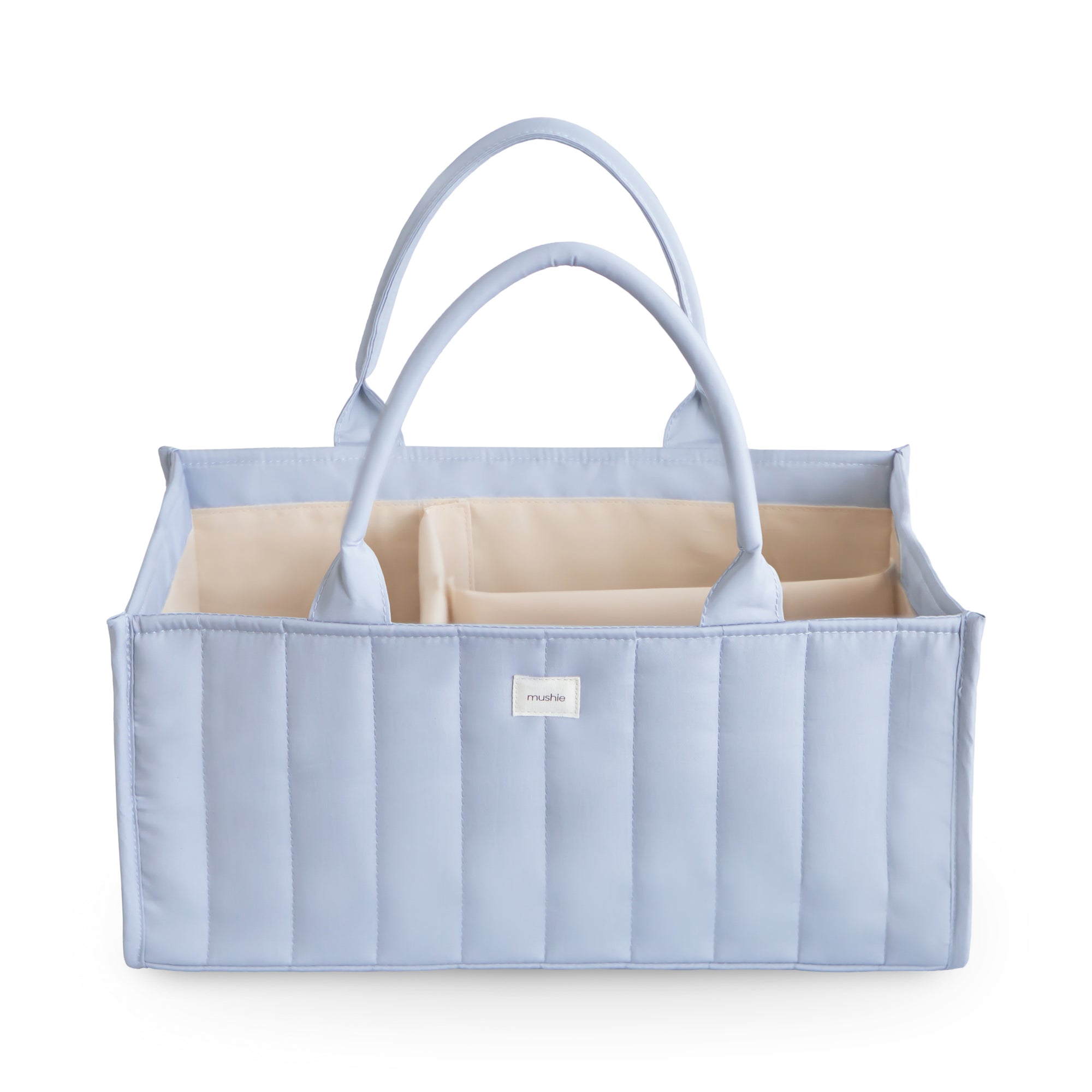Mushie Diaper Caddy in Tradewinds, quilted fabric with handles and beige compartments.