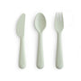 The mushie Dinnerware Cutlery Set is a non-toxic, dishwasher-safe set with a light gray knife, spoon, and fork displayed side by side on a white background.