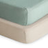 Close-up of two neatly stacked mattresses topped with mushie Extra Soft Muslin Crib Sheets in Roman Green and Fog—perfectly smooth, fitted, and breathable for your baby’s crib. Comes as a 2-pack.