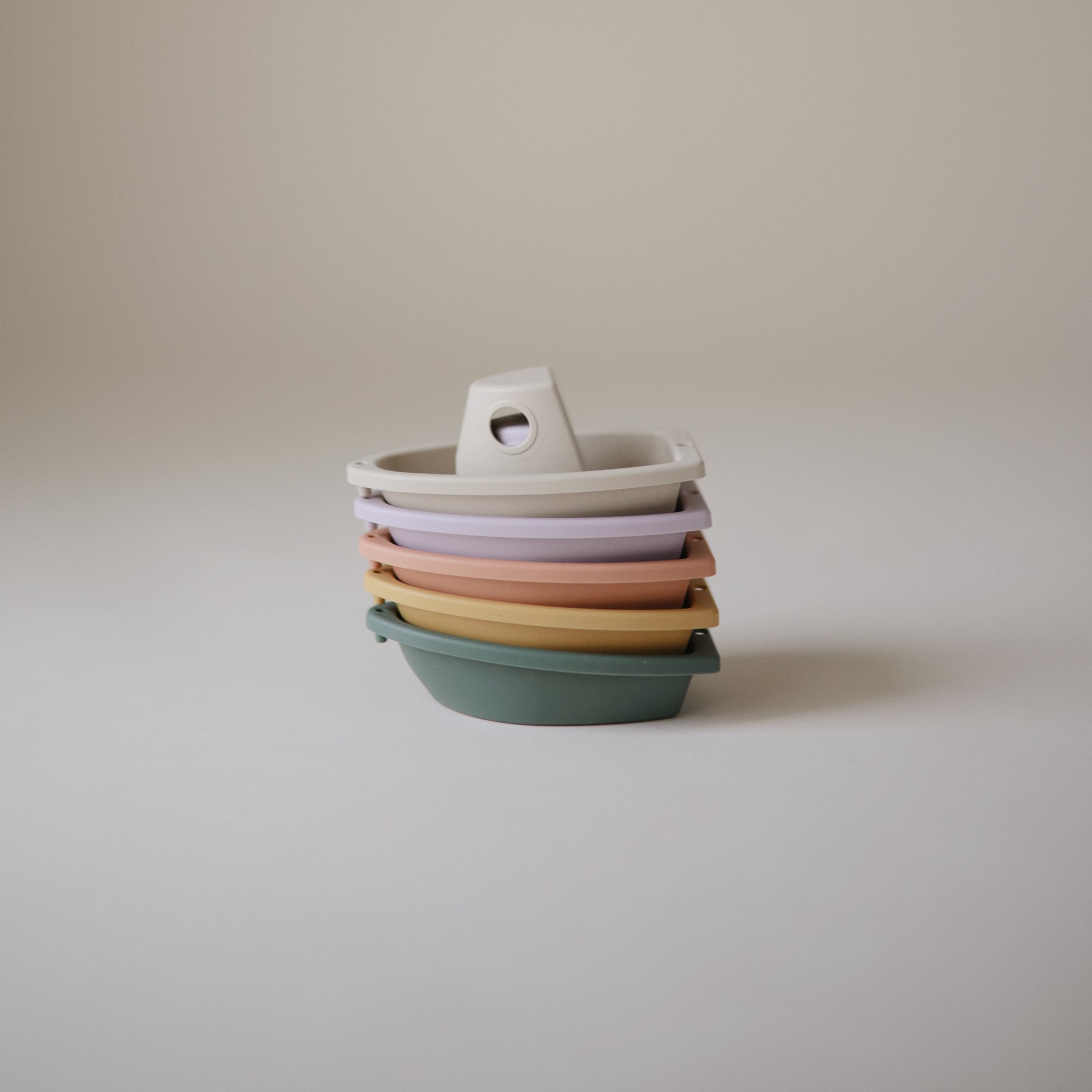 Mushie Bath Boats: stackable, pastel-colored, non-toxic plastic boats with handles.