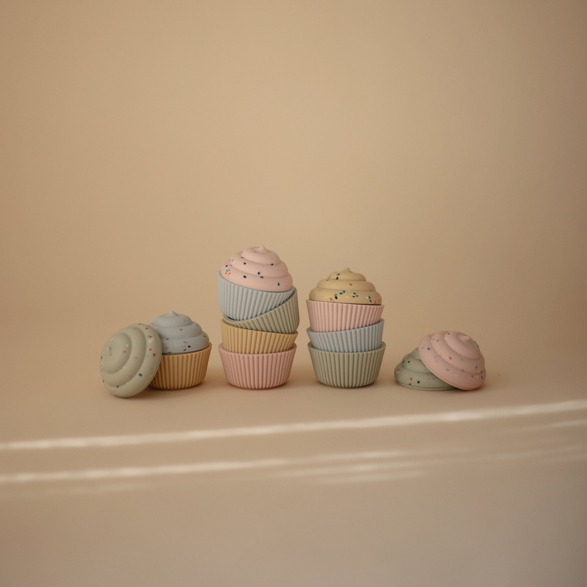 Mushie Mix and Match Toy: pastel silicone cupcakes for color matching and motor skill fun.