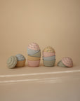 Mushie Mix and Match Toy: pastel silicone cupcakes for color matching and motor skill fun.