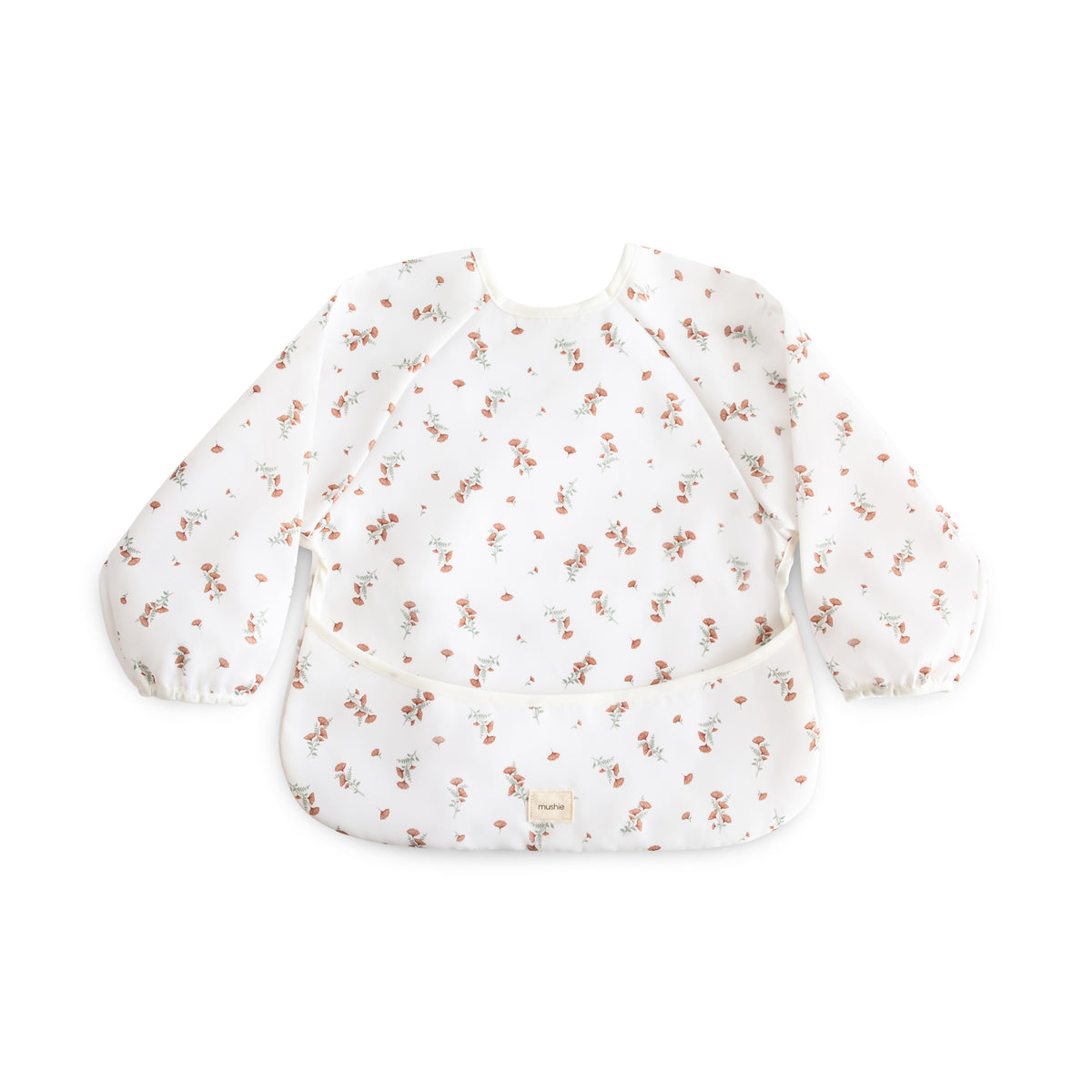 Mushie Long Sleeve Bib in a pink floral print with a front crumb pocket.
