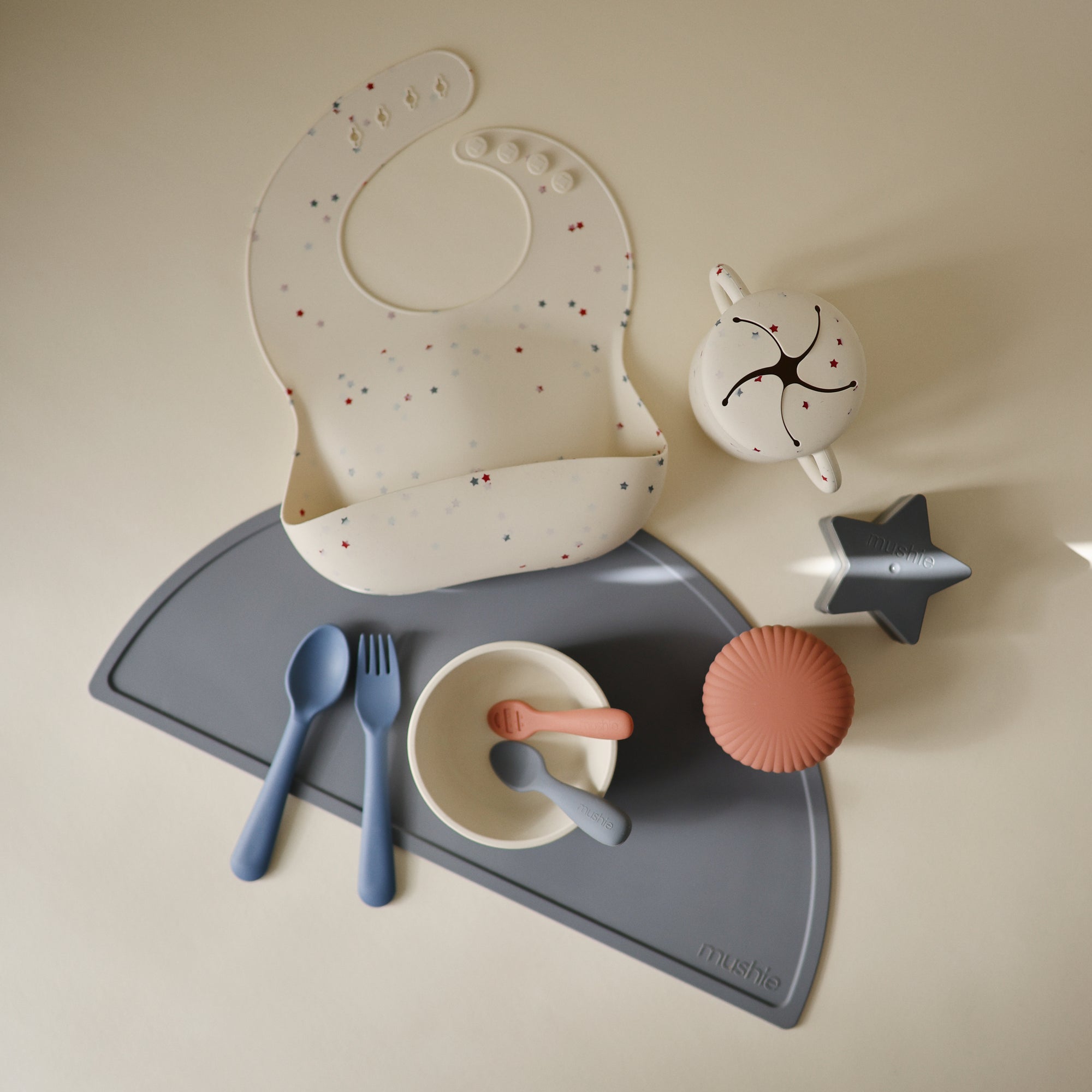 Mushie Silicone Baby Bib with adjustable neck strap, utensils, bowls &amp; cup included.