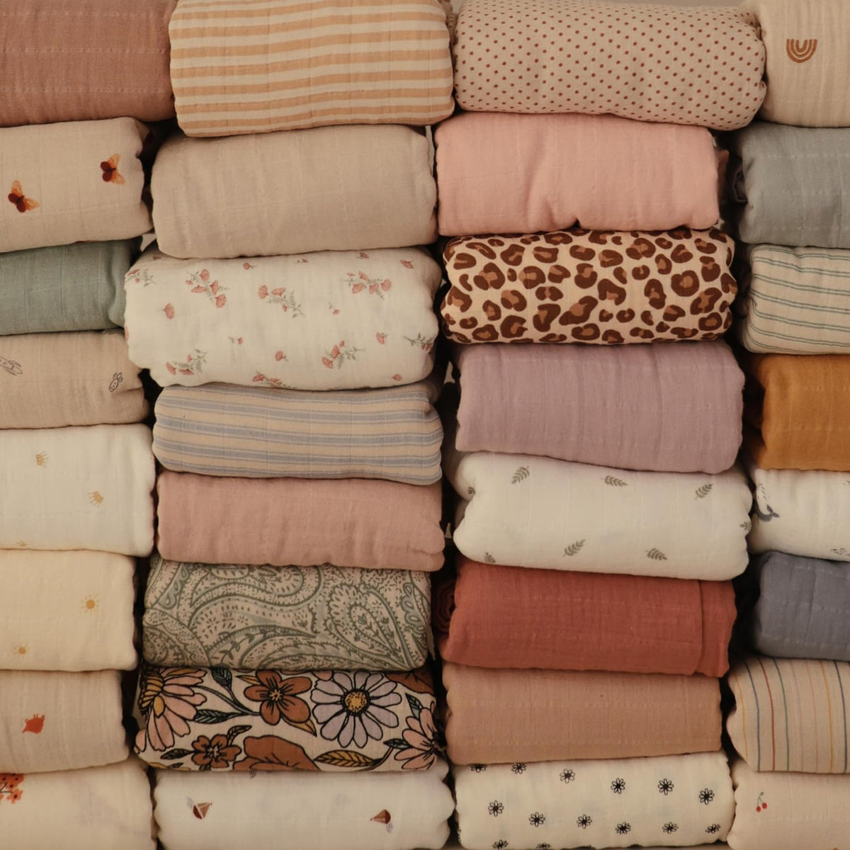 Stack of folded fabrics with various patterns and colors