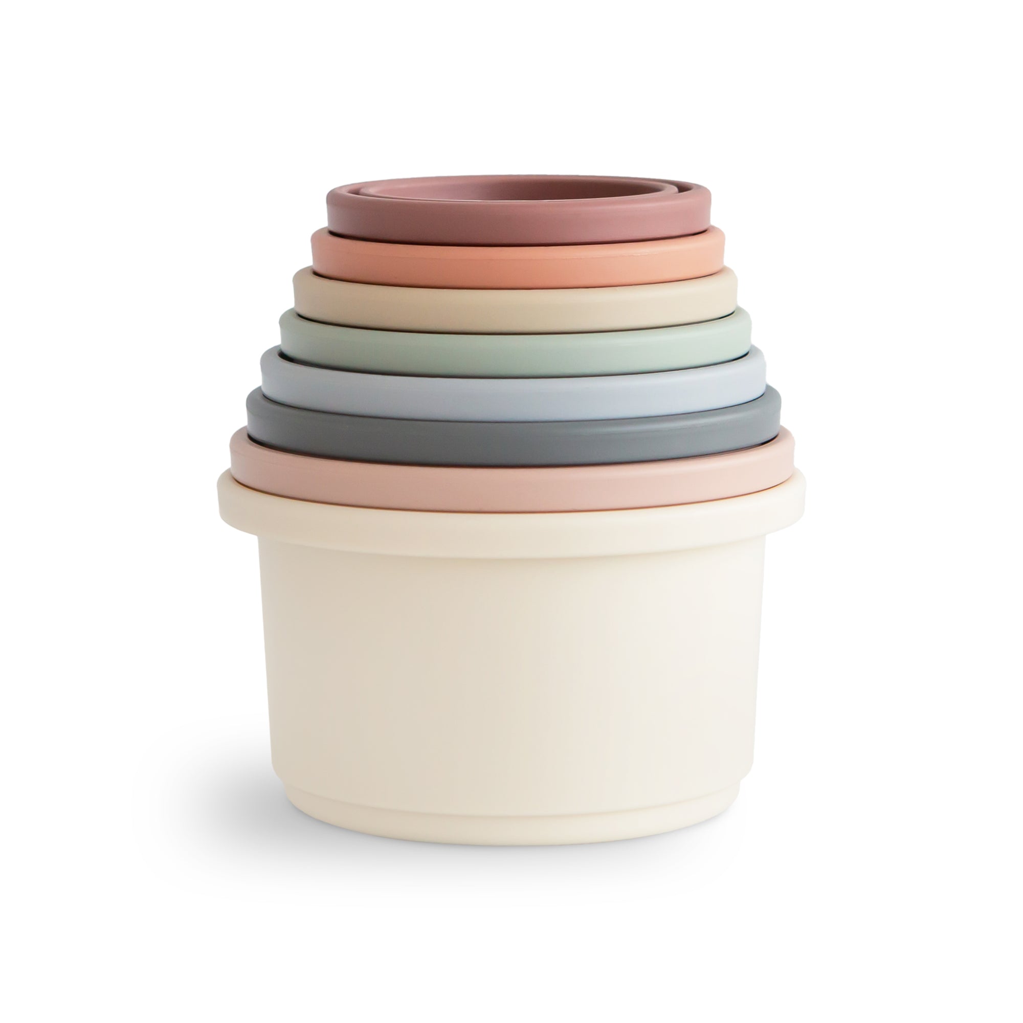 Mushie Stacking Cups Toy in pastel colors, stacked largest to smallest on white background.