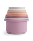 Six pastel mushie Stacking Cups nest from purple to white, inspired by Danish Hygge toys.