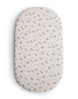 Mushie Extra Soft Bassinet Muslin Crib Sheet in white and pink floral pattern.