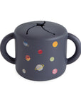 Mushie Snack Cup, Planets: spill-proof silicone, two handles, toddler-friendly.