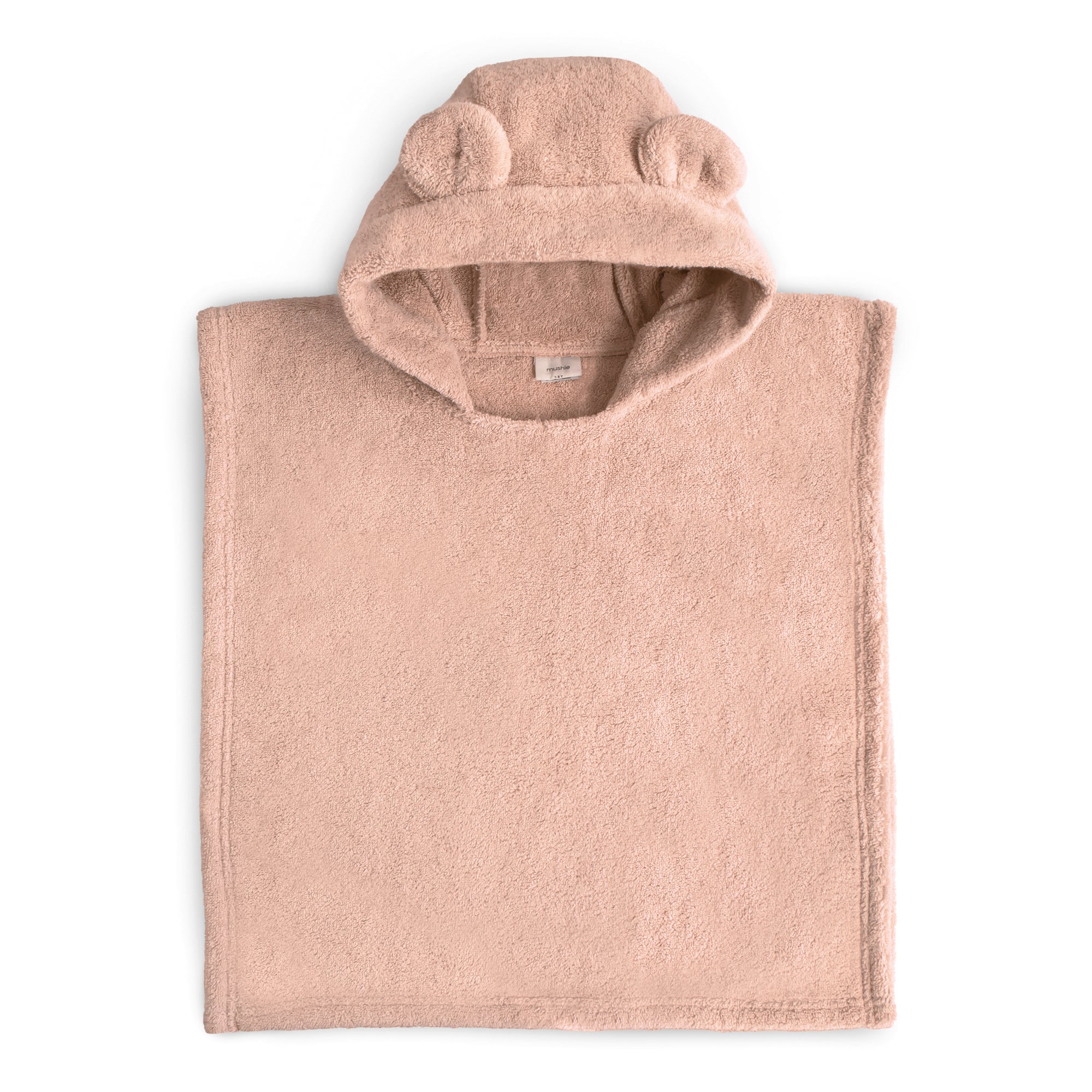 Mushie Bear Poncho Towel in light pink with bear ears, shown flat on a white background.