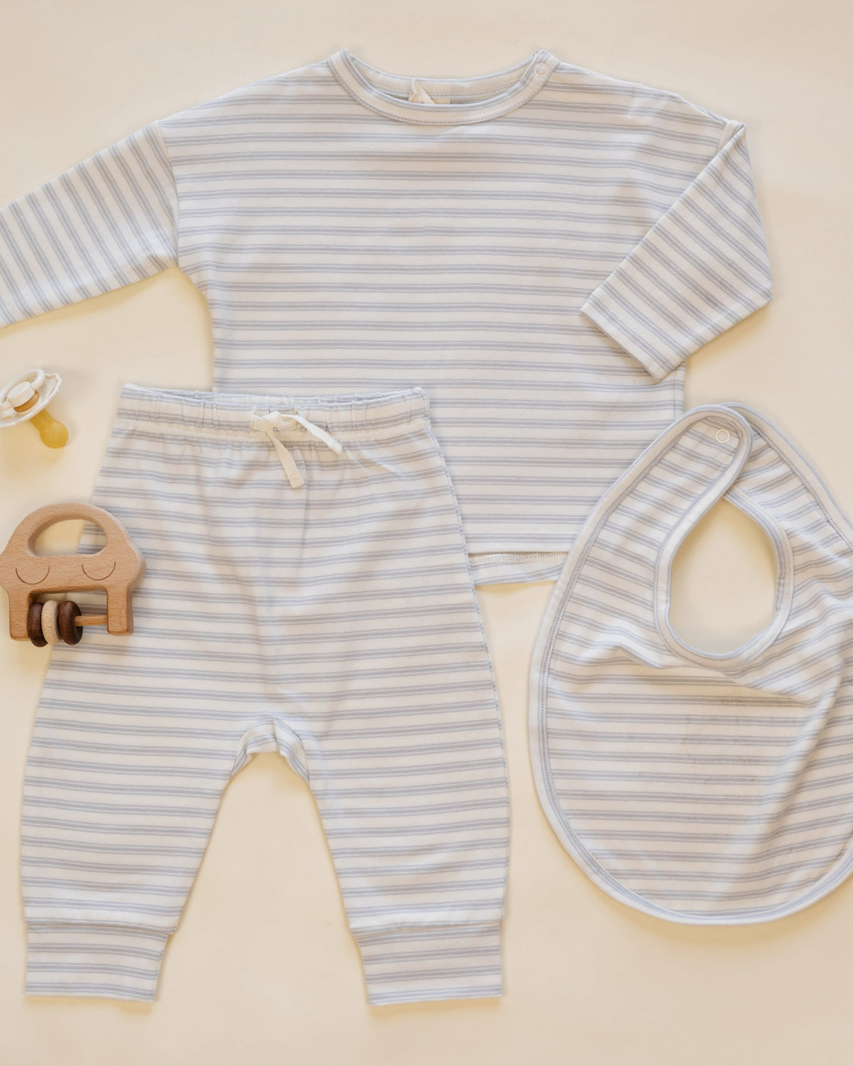Rylee + Cru Drawstring Pant Cloud Stripe baby set: long sleeves, elastic pants, bib, pacifier.
