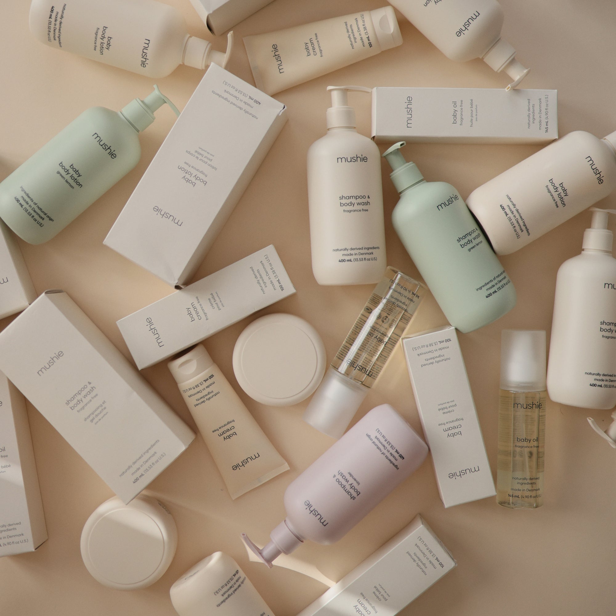 Mushie Baby Body Lotion with natural ingredients and packaging featuring bottles and boxes.