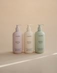 Three mushie Baby Shampoo & Body Wash bottles for delicate skin on a beige background.