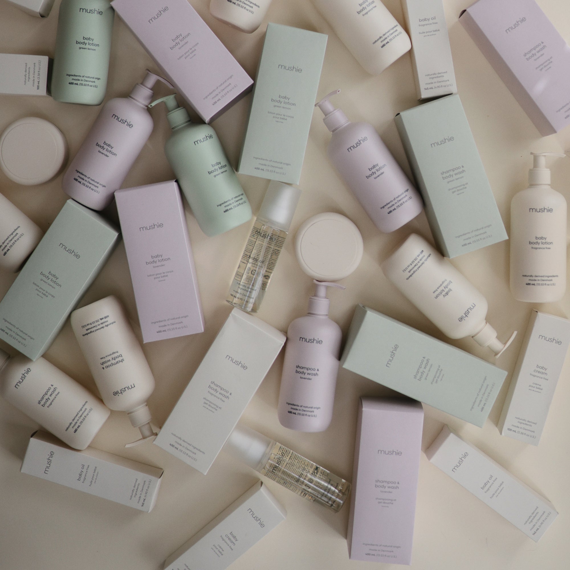 Mushie Baby Body Lotion with natural ingredients on a light surface.
