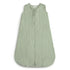 The mushie Organic Cotton Sleep Bag is sleeveless and light green, made from soft, textured breathable fabric with a front zipper, shown flat on a white background.