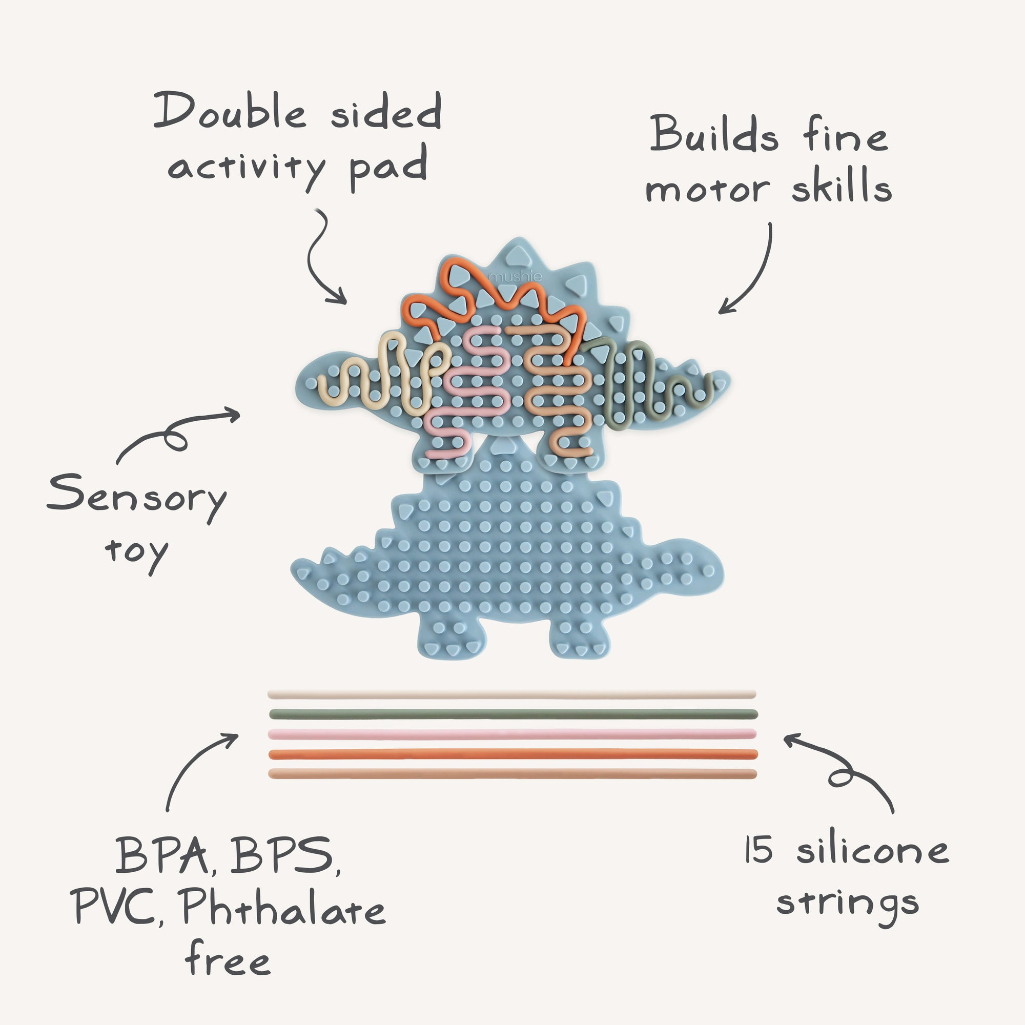 Mushie Silicone Sensory Toy: blue dinosaur shape with labeled features for fine motor play.