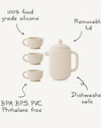 The Mushie Silicone Tea Play Set features a cream-colored pot with removable lid and three cups. Made from 100% food grade silicone, it’s dishwasher safe and free of BPA, BPS, PVC, and phthalates—perfect for pretend play!.
