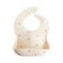 Mushie Silicone Baby Bib: cream, bird & star print, adjustable strap, easy-clean pocket.