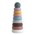 The mushie Stacking Rings Toy features nine pastel, non-toxic, donut-shaped rings with a round top, stacked in decreasing size from bottom to top, displayed against a white background.
