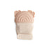 The mushie Rainbow Teething Mitten is a beige fabric mitten with a soft, light brown silicone top featuring rainbows and bear ears, providing a textured surface for babies to chew.