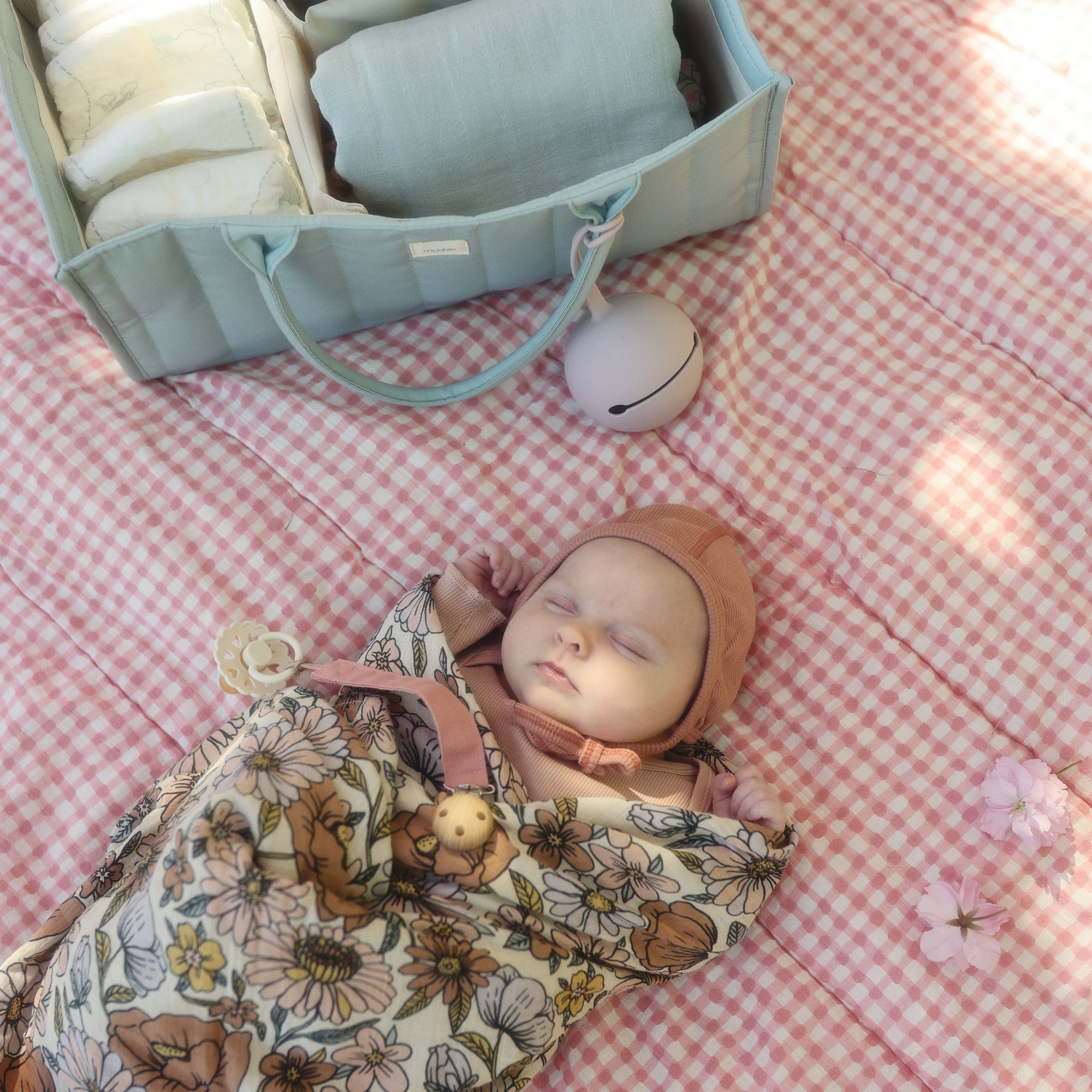 Baby on a pink checkered blanket with FRIGG Andersen Fairytale Natural Rubber Pacifier.