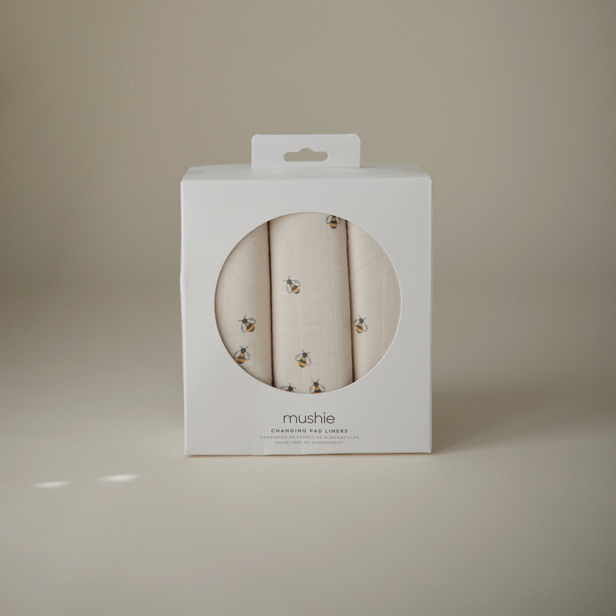 Mushie Changing Pad Liners—set of 3 organic cotton muslin liners with a small bee pattern.