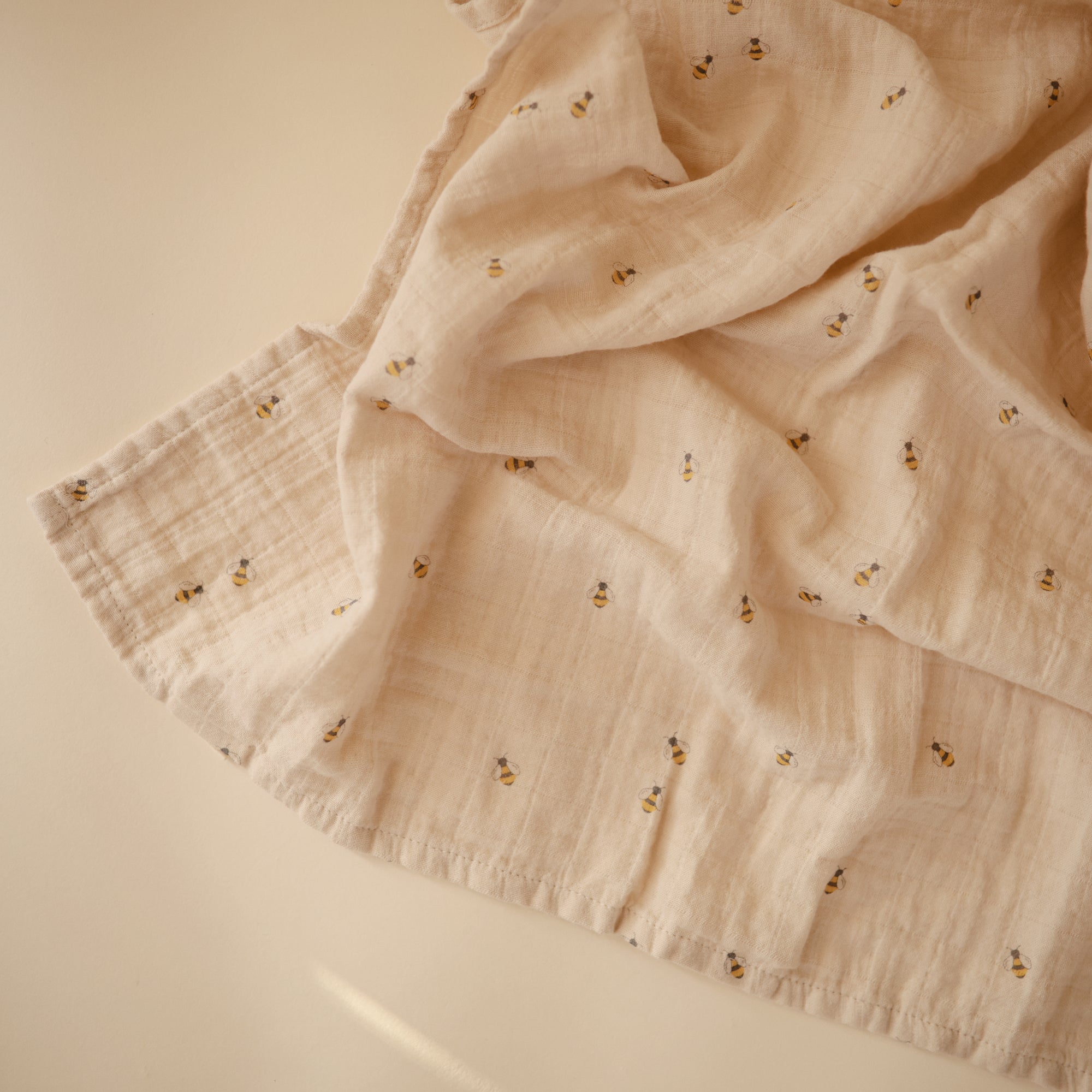 Lifestyle image of Organic Cotton Swaddle in Bees