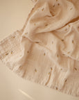 Lifestyle image of Organic Cotton Swaddle in Bees