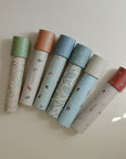 Six mushie Kaleidoscopes with colorful caps, ideal for exploratory play.