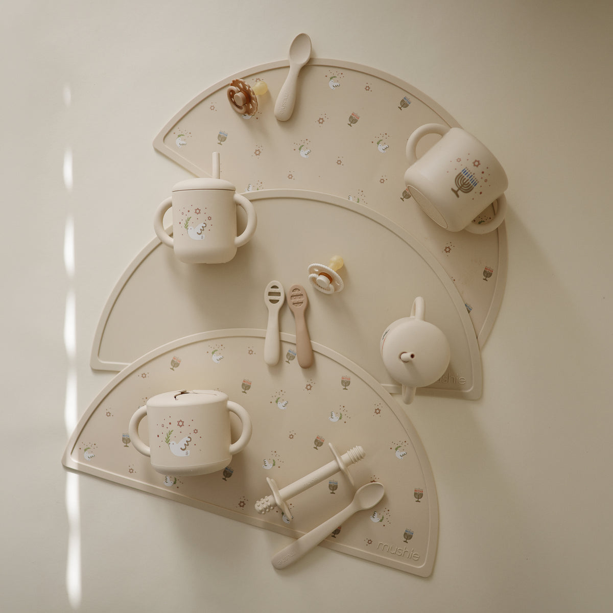 Hanukkah Doves Feeding Kit featuring toddler cups, spoons, mats, and pacifiers.