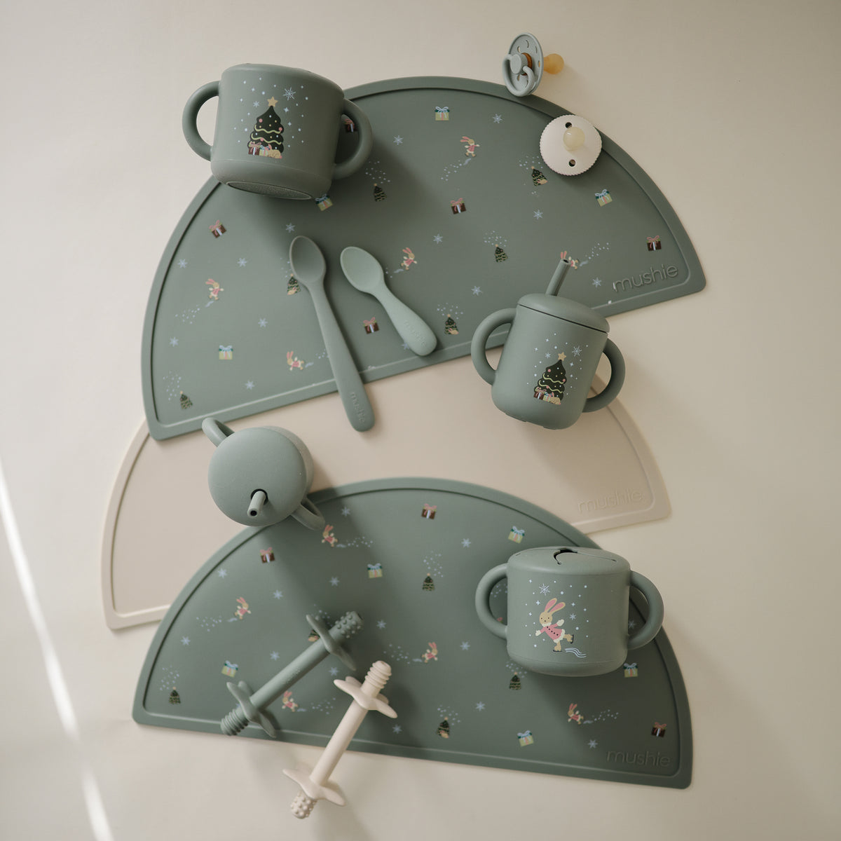 Christmas Bunny Feeding Kit containing holiday-themed silicone cups, spoons, and placemats.