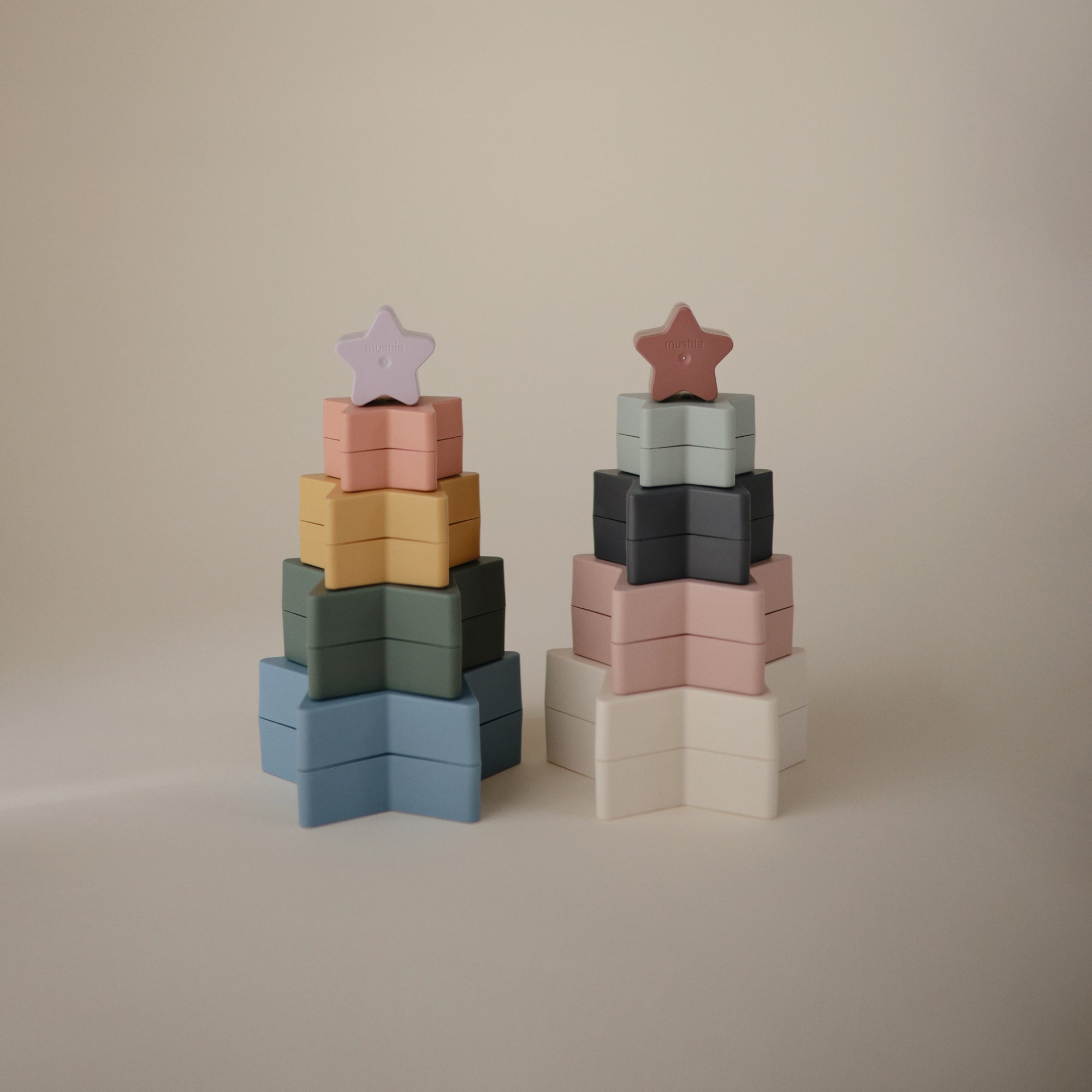 Two mushie Nesting Stars Toys sit side by side on a plain background.