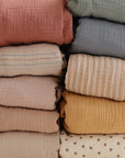 Mushie Mini Muslin Crib Sheet—breathable, soft cotton bedding for your baby’s crib.