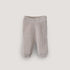 The mushie Chunky Knit Pants in light beige are made from organic cotton, with a ribbed waistband and cuffs, plus a textured pattern, shown against a plain white background.