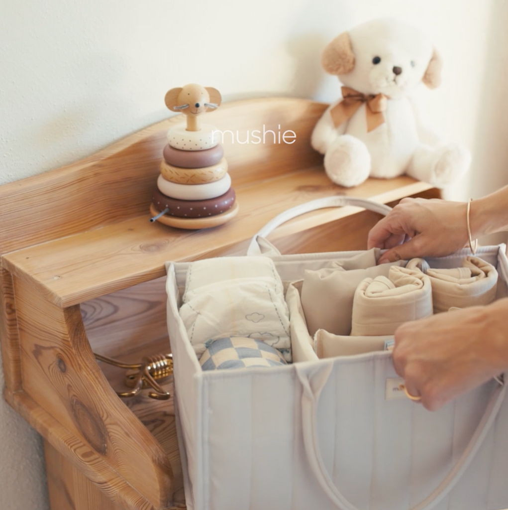 Lifestyle video of the mushie diaper caddies, being used with young mothers to fill with diapers, skincare, and swaddles. 
