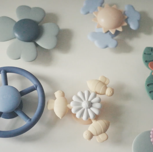 Product video of the suction spinner toys being used by little children while eating at the tables, while riding in a car, and in the bath. 