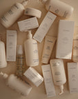 Several mushie Baby Body Lotion bottles and boxes displayed on a neutral background.