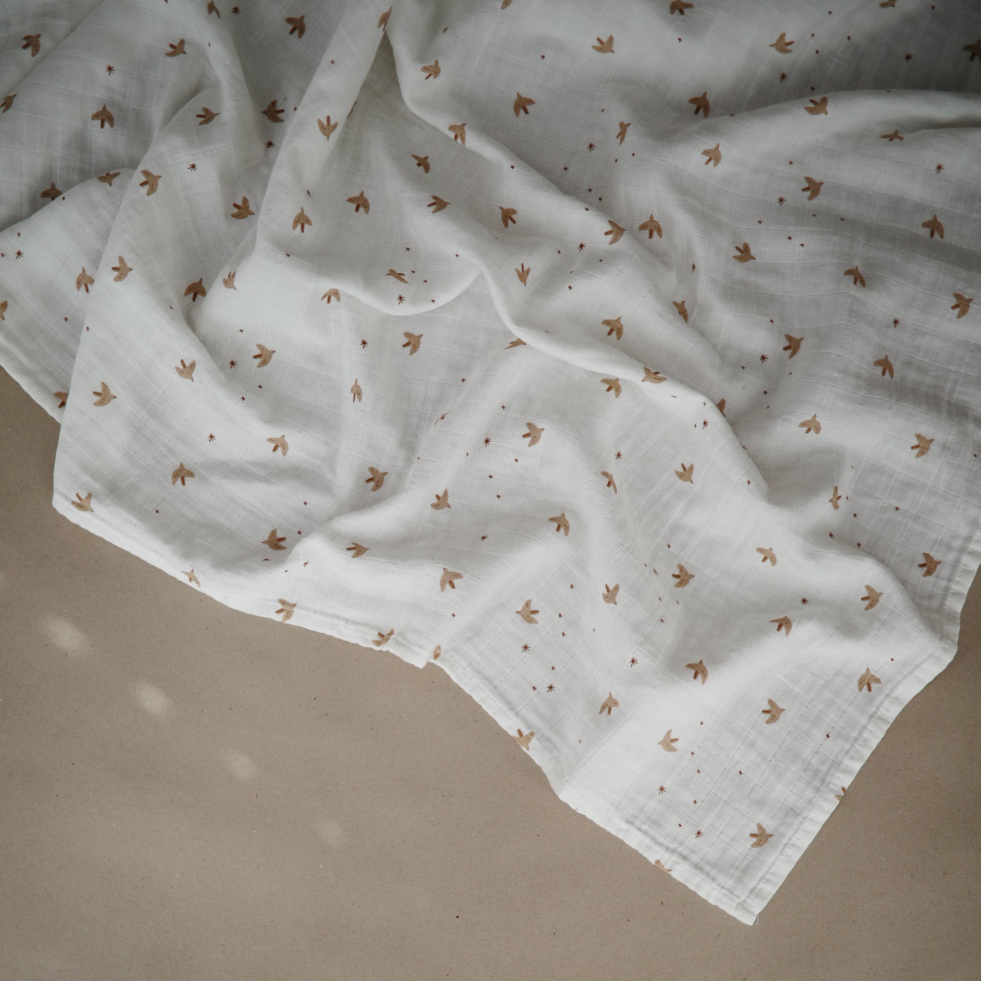 Lifestyle image of Organic Cotton Swaddle in Sparrow